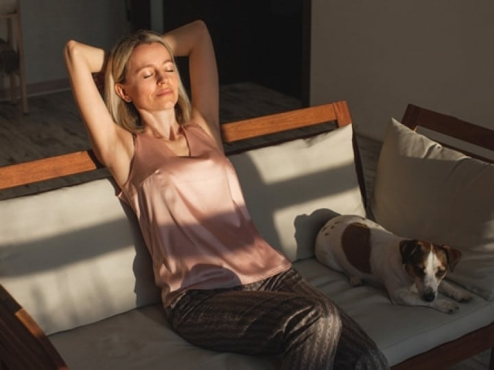 Woman relaxing with a dog in clean air.