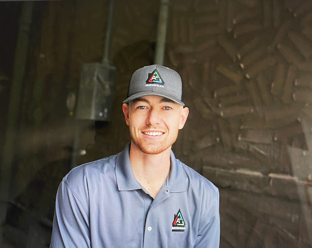 HVAC contractor with branded hat and shirt