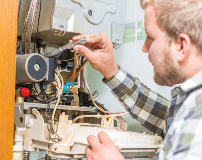 man working on a furnace